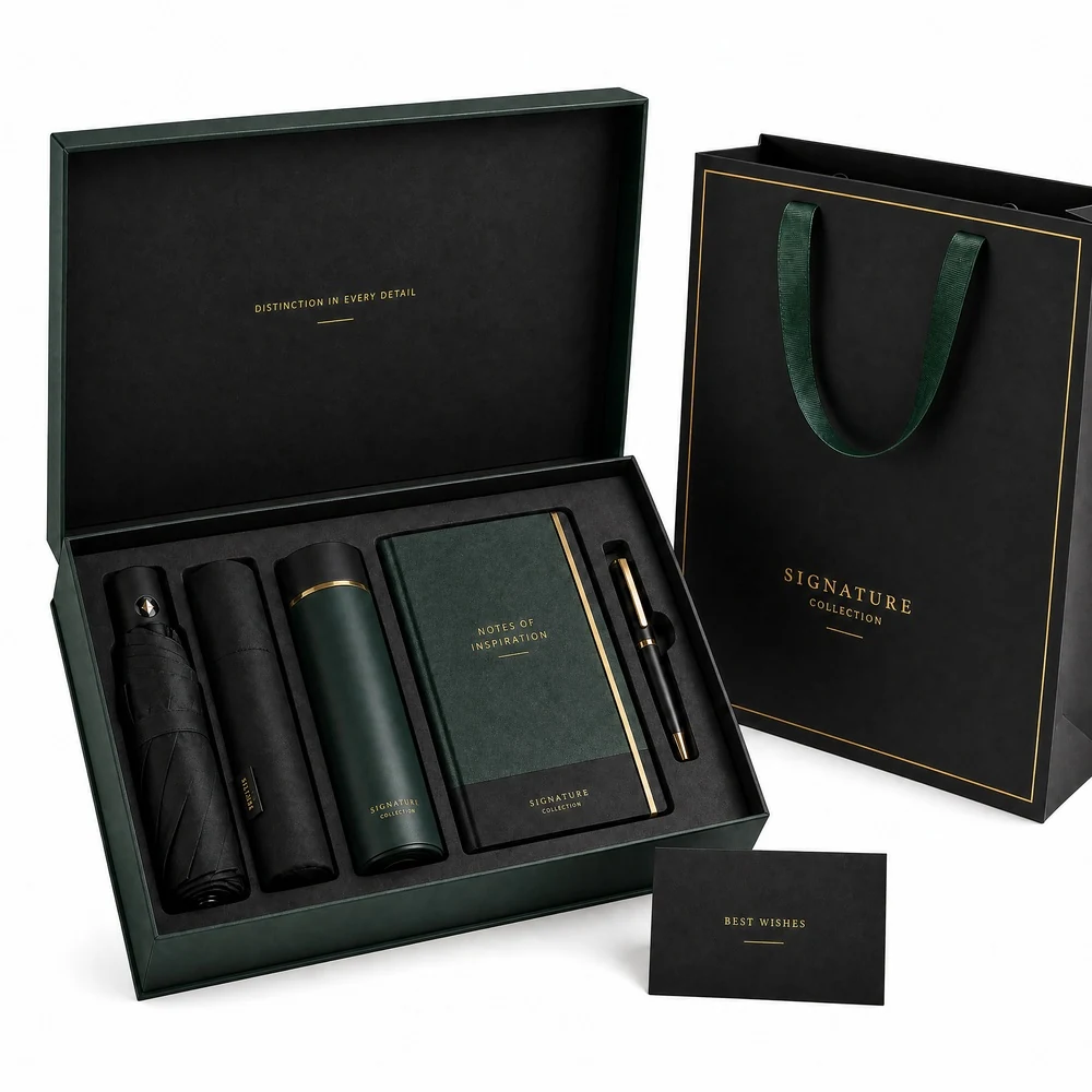 Open green corporate gift box with umbrella, insulated bottle, notebook and pen beside matching bag